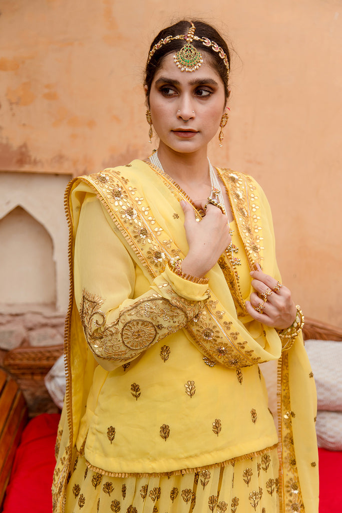 Photo of Yellow mehendi lehenga with open hair and floral jewellery